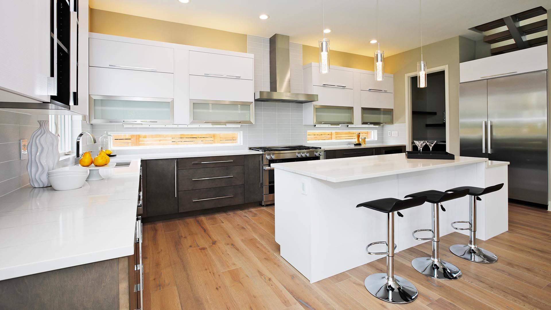 A Kitchen with White Cabinets and Stainless Steel Appliances — Sheridan Stone Aust in Toormina, NSW