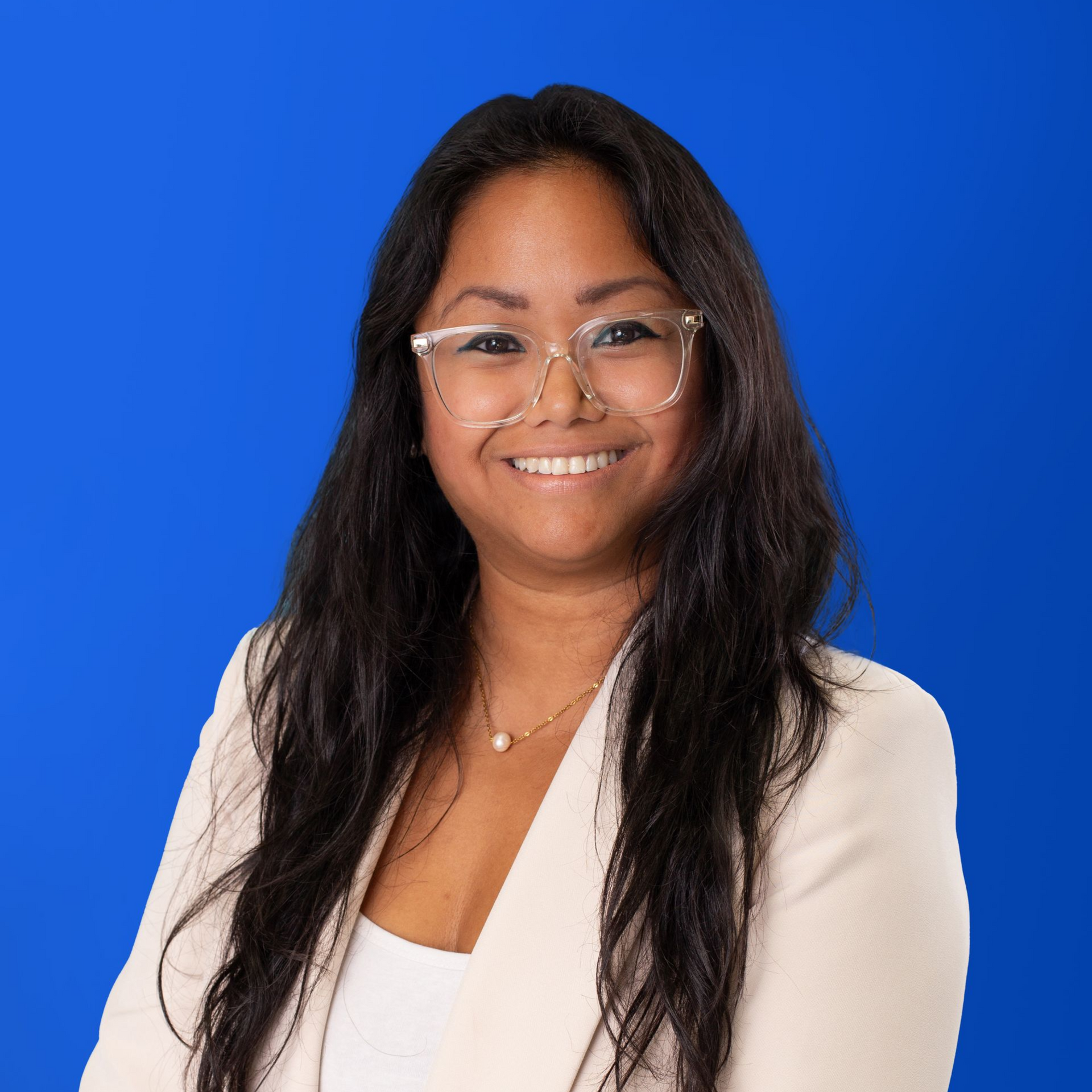A man with a beard is wearing a suit and smiling