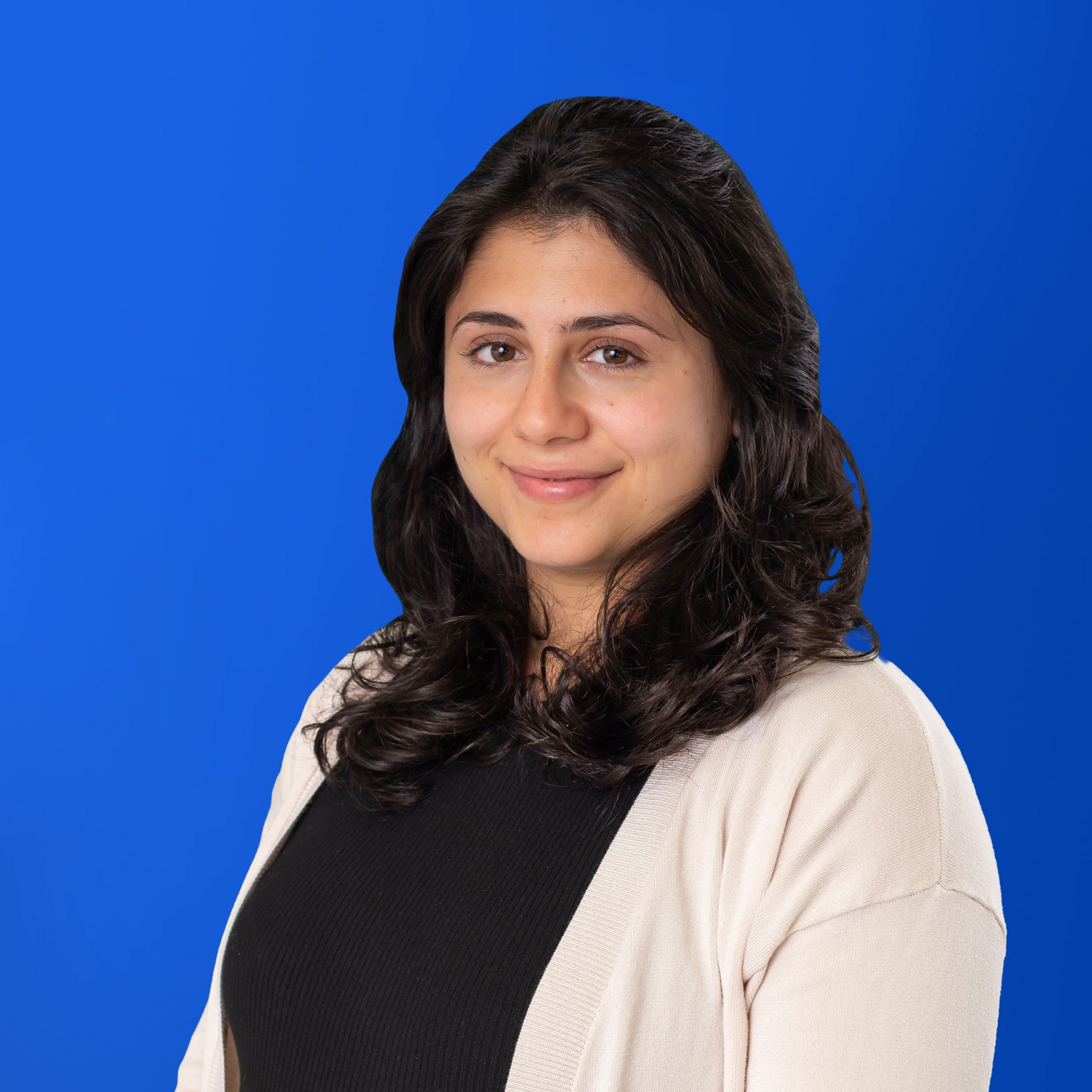 A woman with long dark hair is smiling in a yellow circle