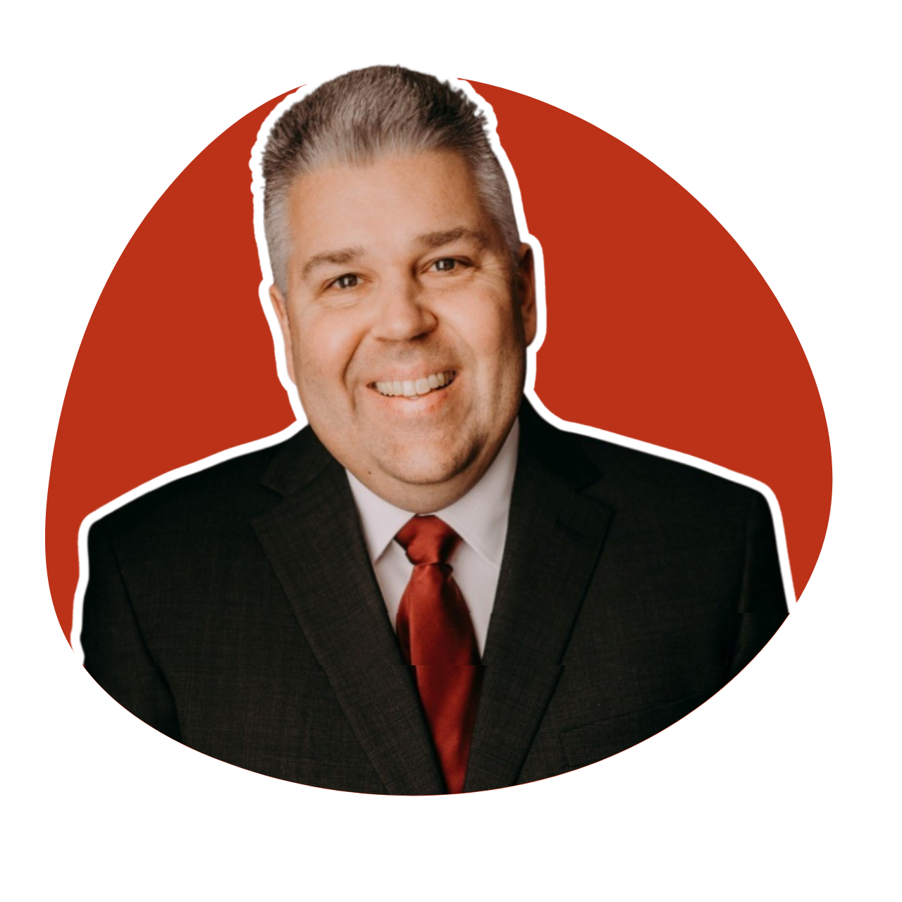A man with curly hair is smiling in a red circle