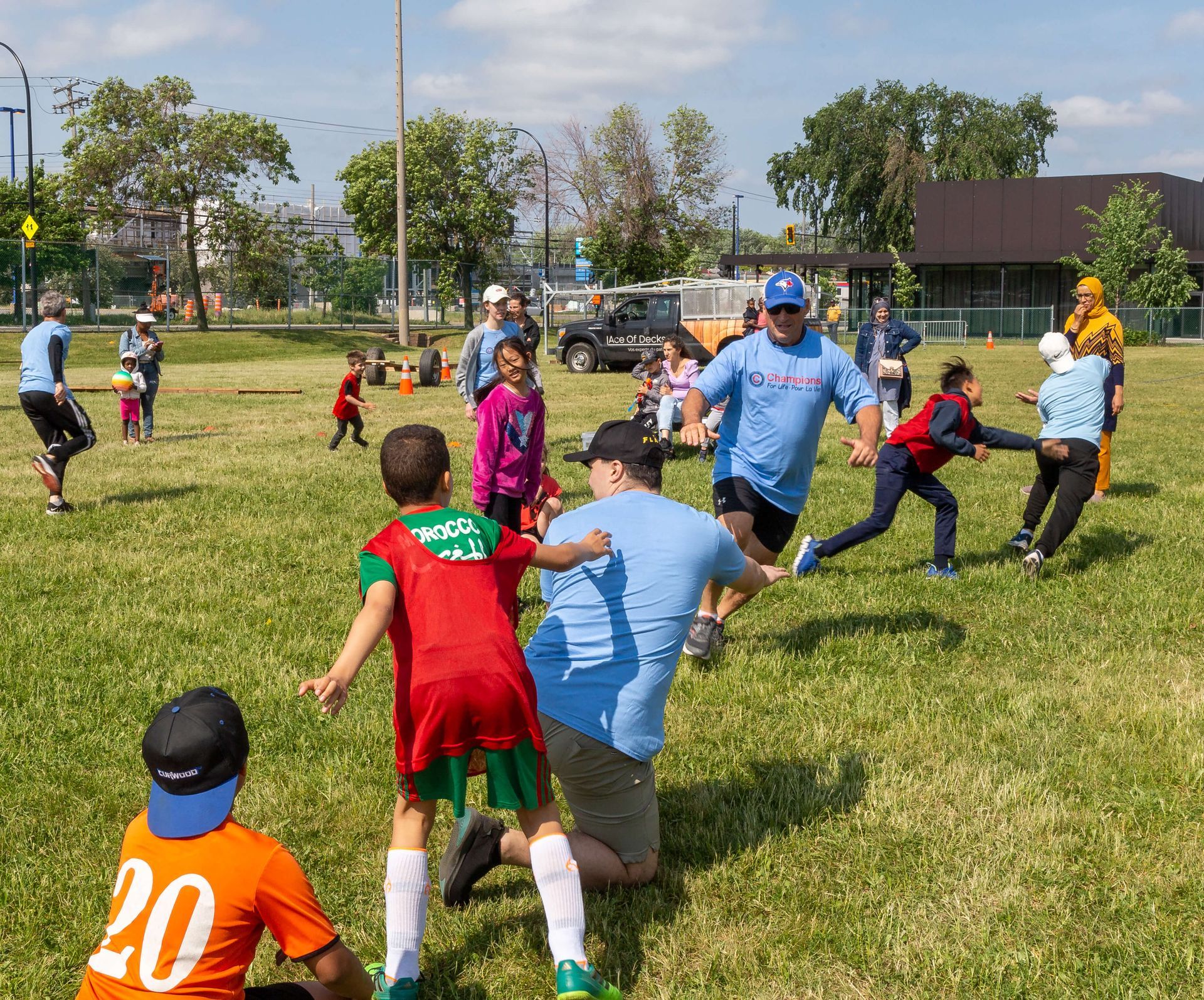 A group of children playing tag outdoors in a field