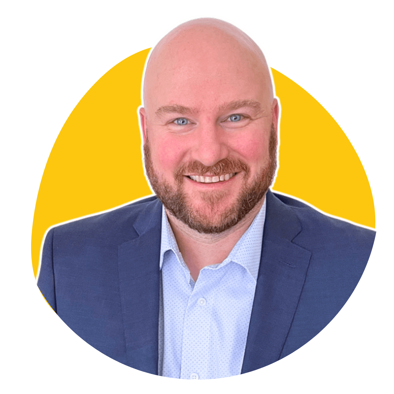A bald man with a beard is wearing a suit and smiling