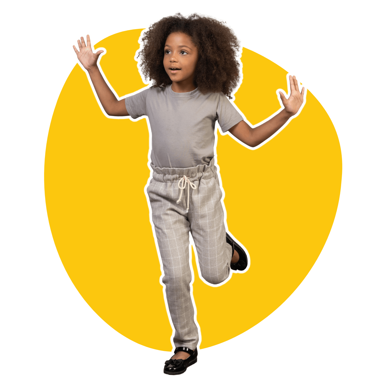 A young boy in a green shirt and khaki shorts is jumping in the air because he is happy at school