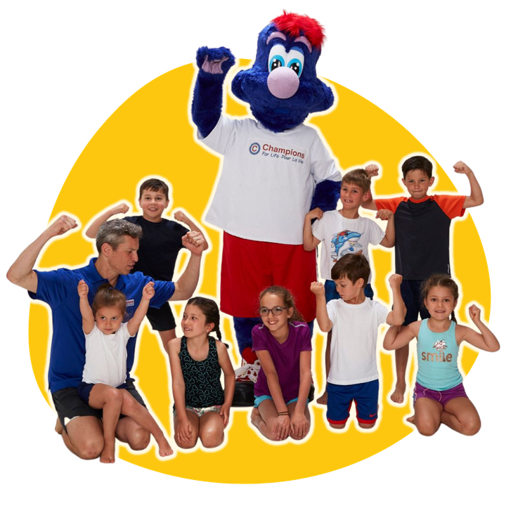 A group of children posing for a picture with a mascot