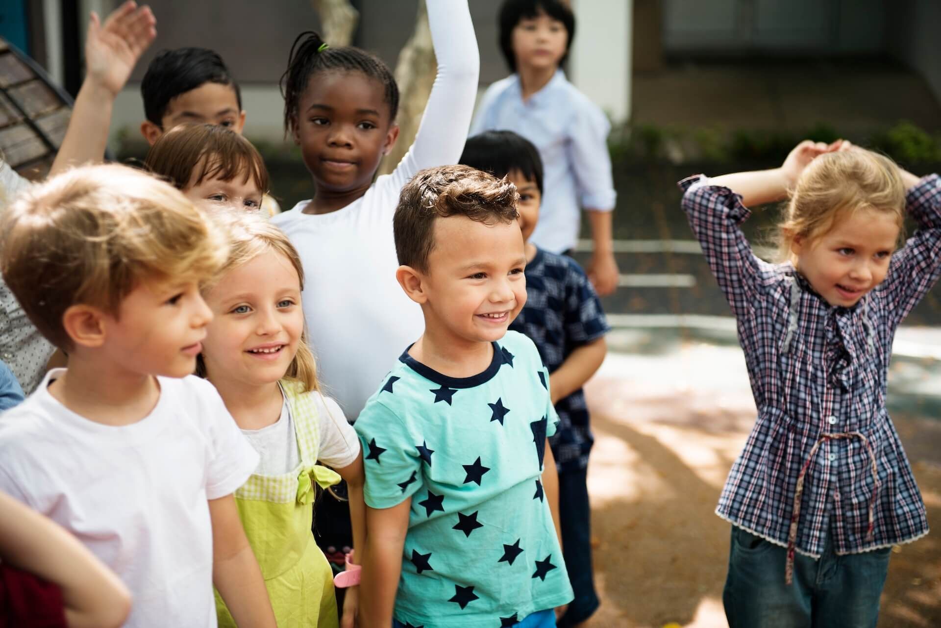 A group of children are standing next to each other in a line.