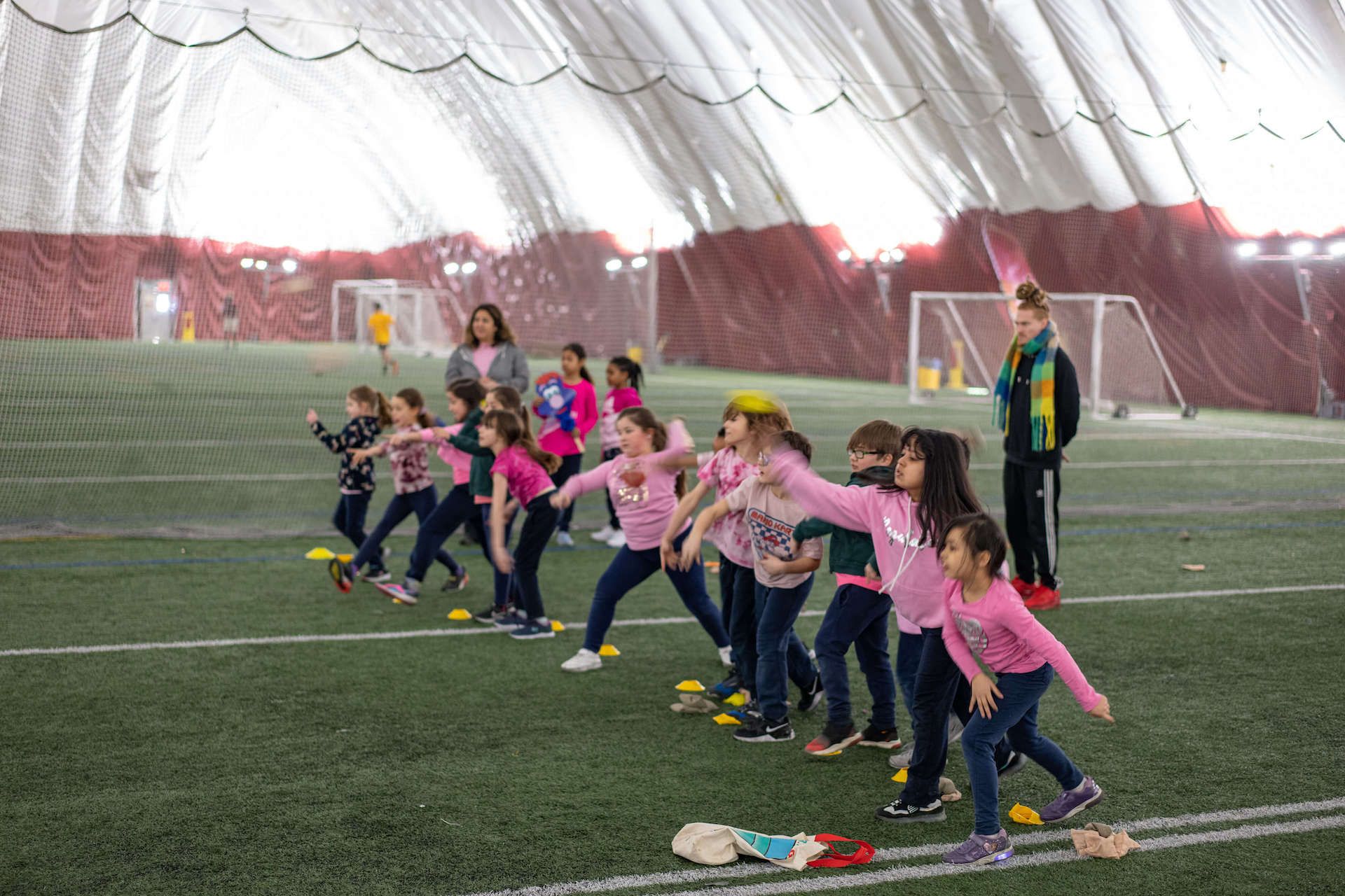 A group of children are playing on a soccer field.