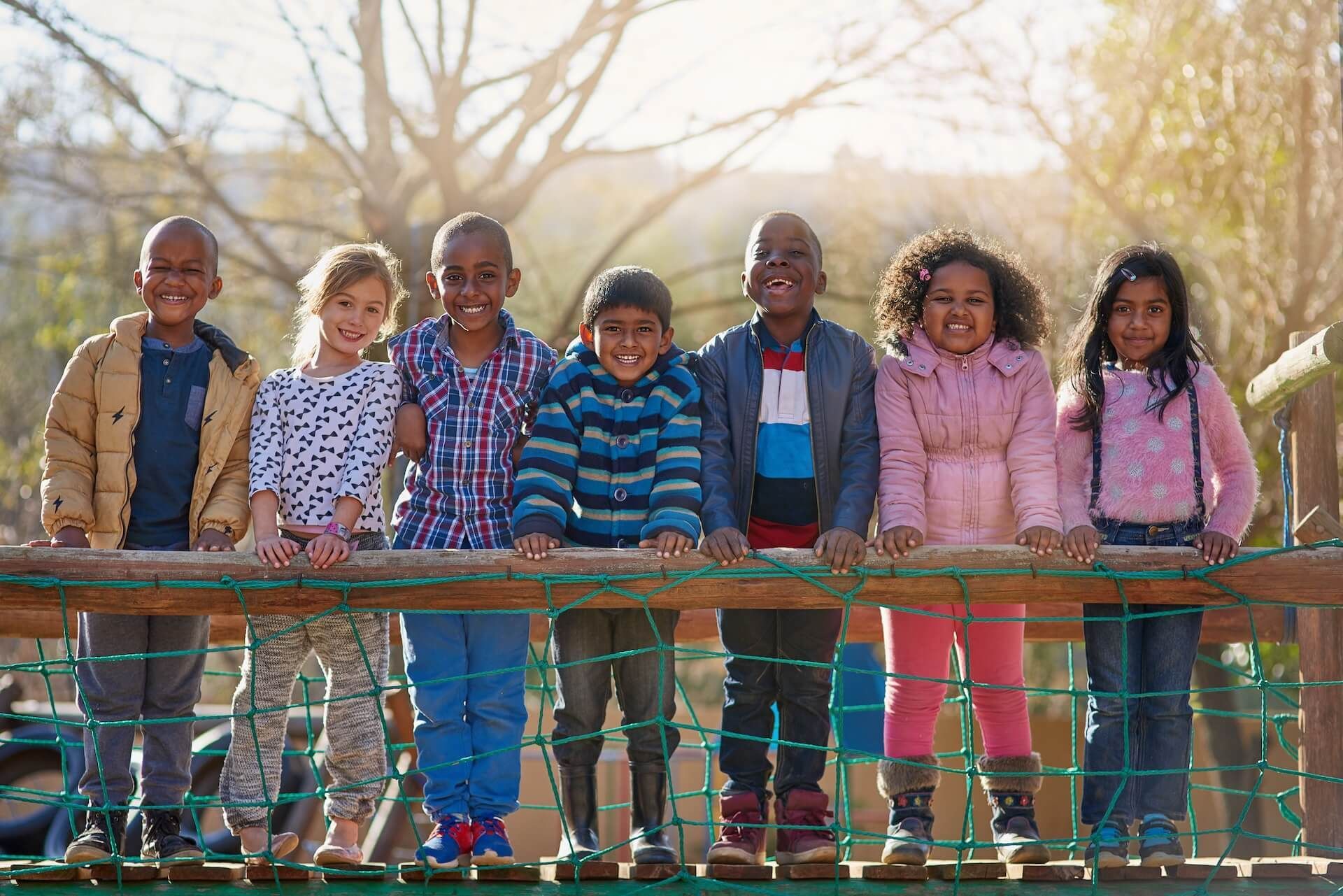 A group of children are standing next to each other during school recess