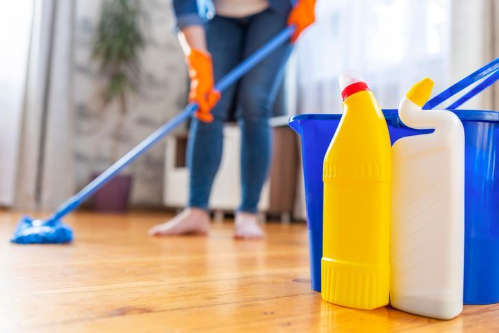 House cleaning concept with cleaning products and mop