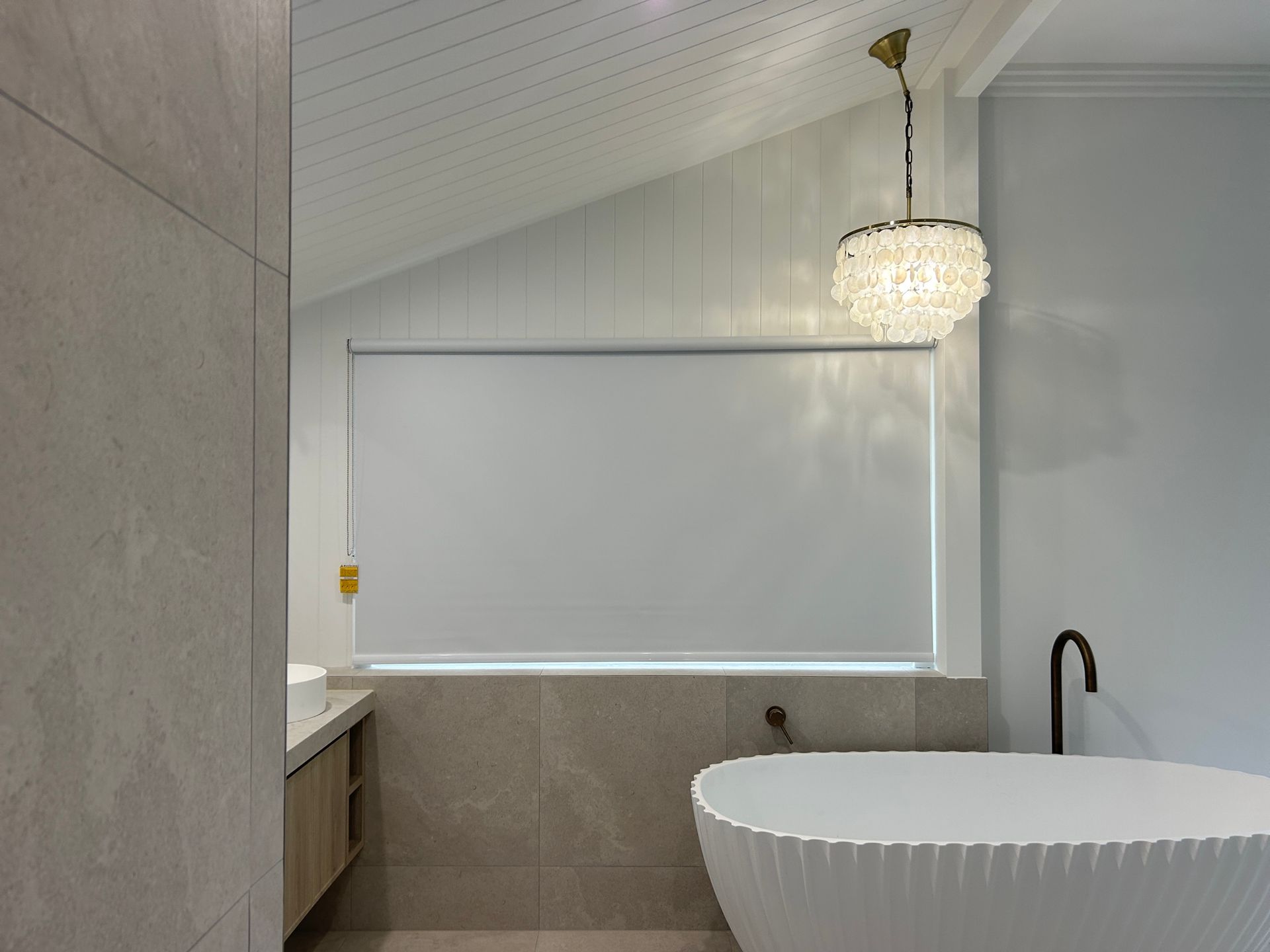 a room with a desk , chair , bookshelf and window.