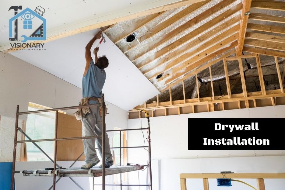Contractor on scaffolding working on a drywall installation living room job in Markham, Ontario.