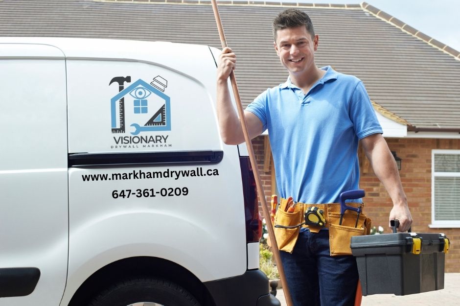 A contractor with tools and a drywall company van at a residential home in Markham, ON.