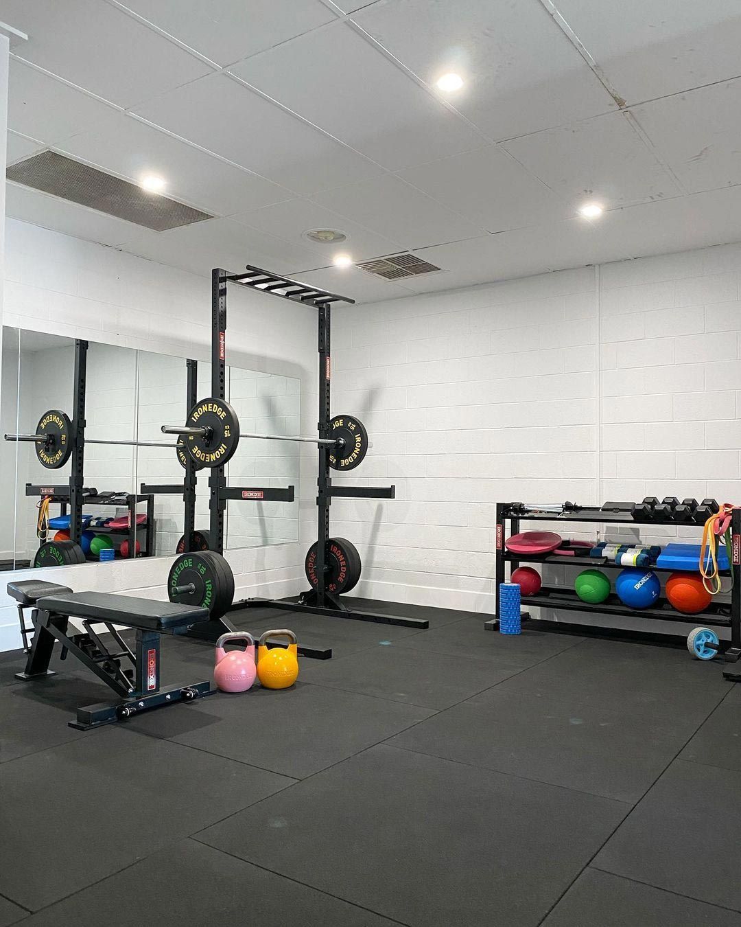 Gym With a lot of Exercise Equipment And a Large Mirror — Return to Performance Physiotherapy in Epsom, VIC
