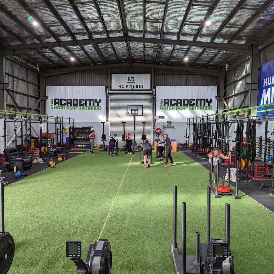 Inside a Large Gym: People Exercising, Turf Floor, Weights, Racks, and Fitness Equipment — Return to Performance Physiotherapy in Epsom, VIC