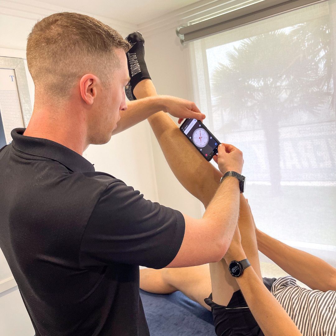 A Man Helping a Client With Knee Pain — Return to Performance Physiotherapy In Epsom, VIC