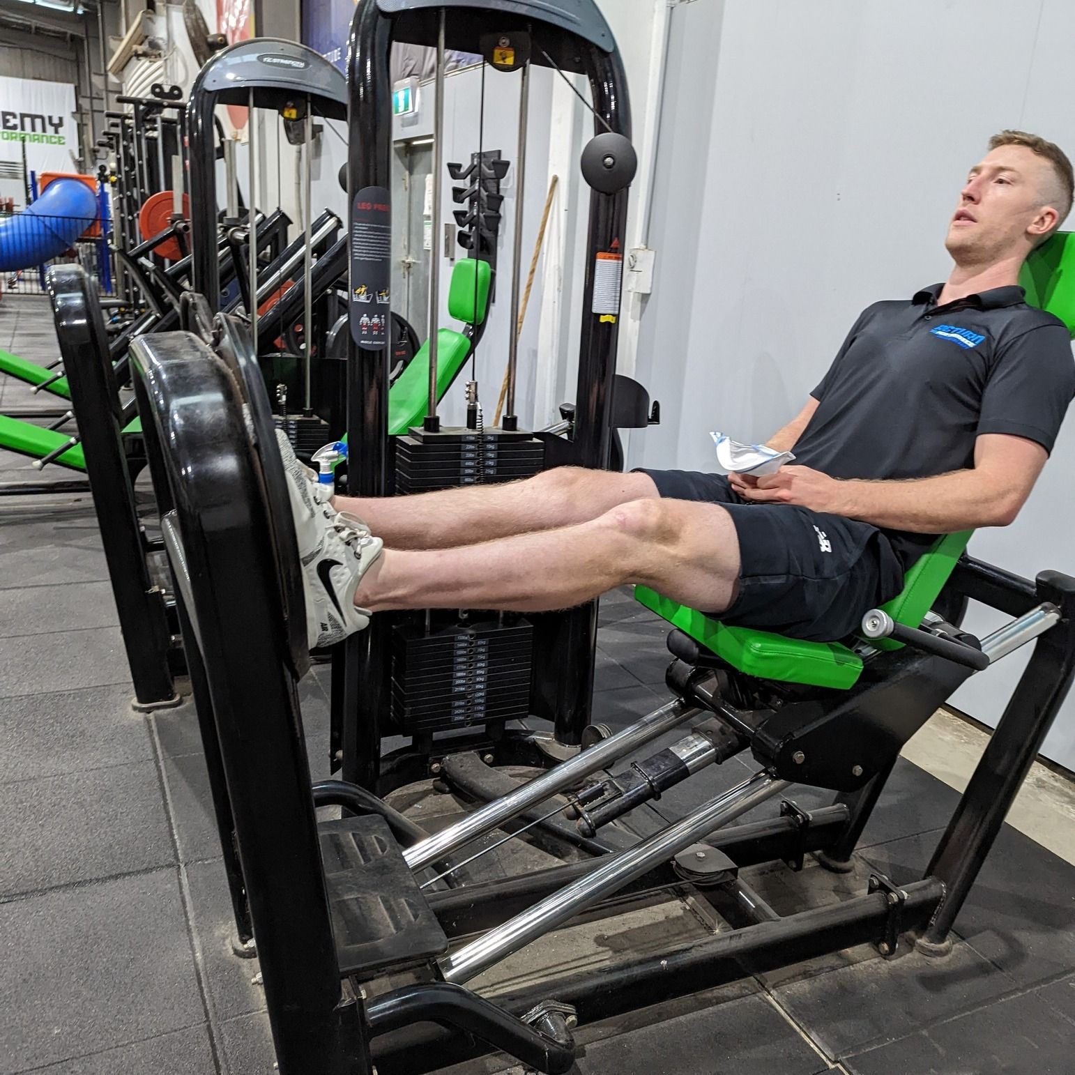 A Person Sitting on a Gym Leg Press Machine — Return to Performance Physiotherapy in Epsom, VIC
