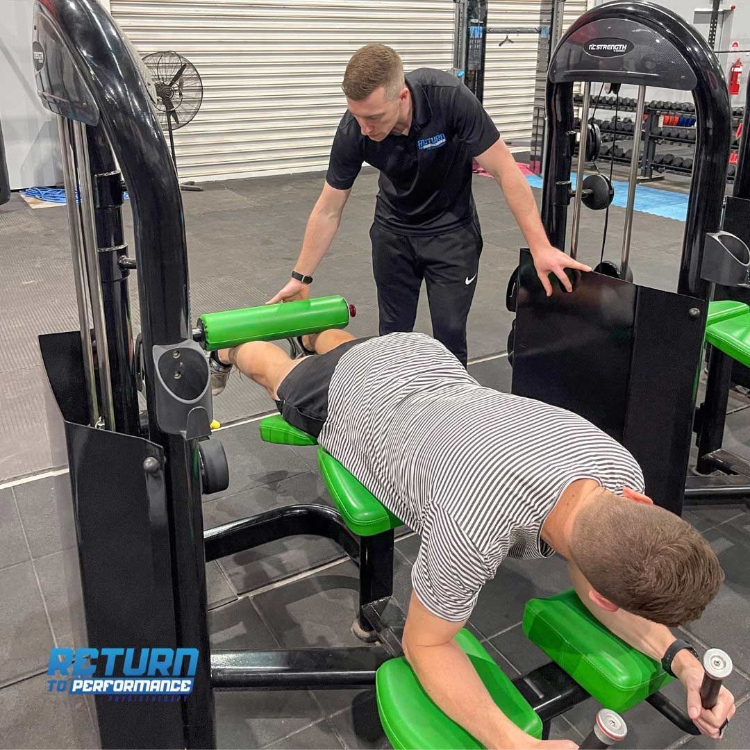 Expert Physiotherapist Guiding a Man Through a Focused Exercise Session — Return to Performance Physiotherapy in Epsom, VIC