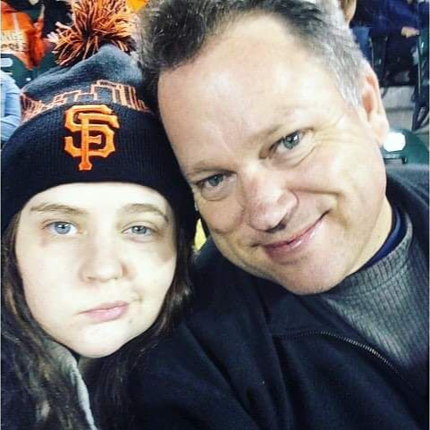 A photo of Sarah Wood in a San Francisco Giants beanie and her dad Eric Wood.