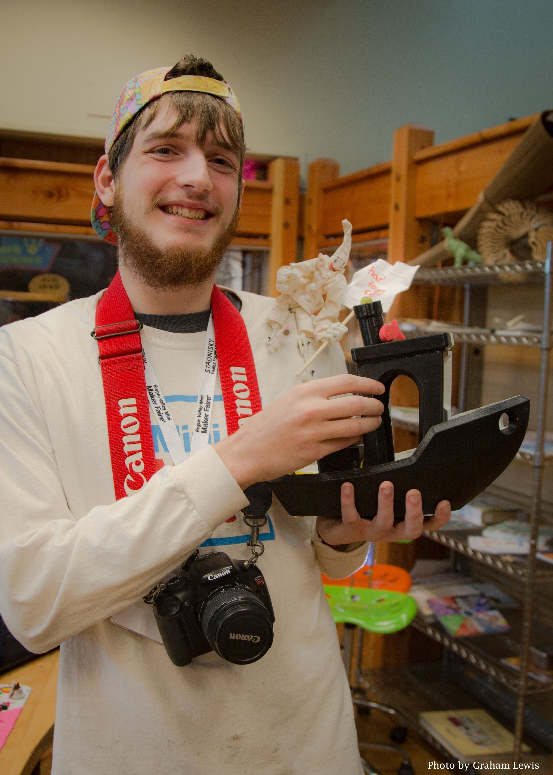 A volunteer showing off a Tinkering Studio creation