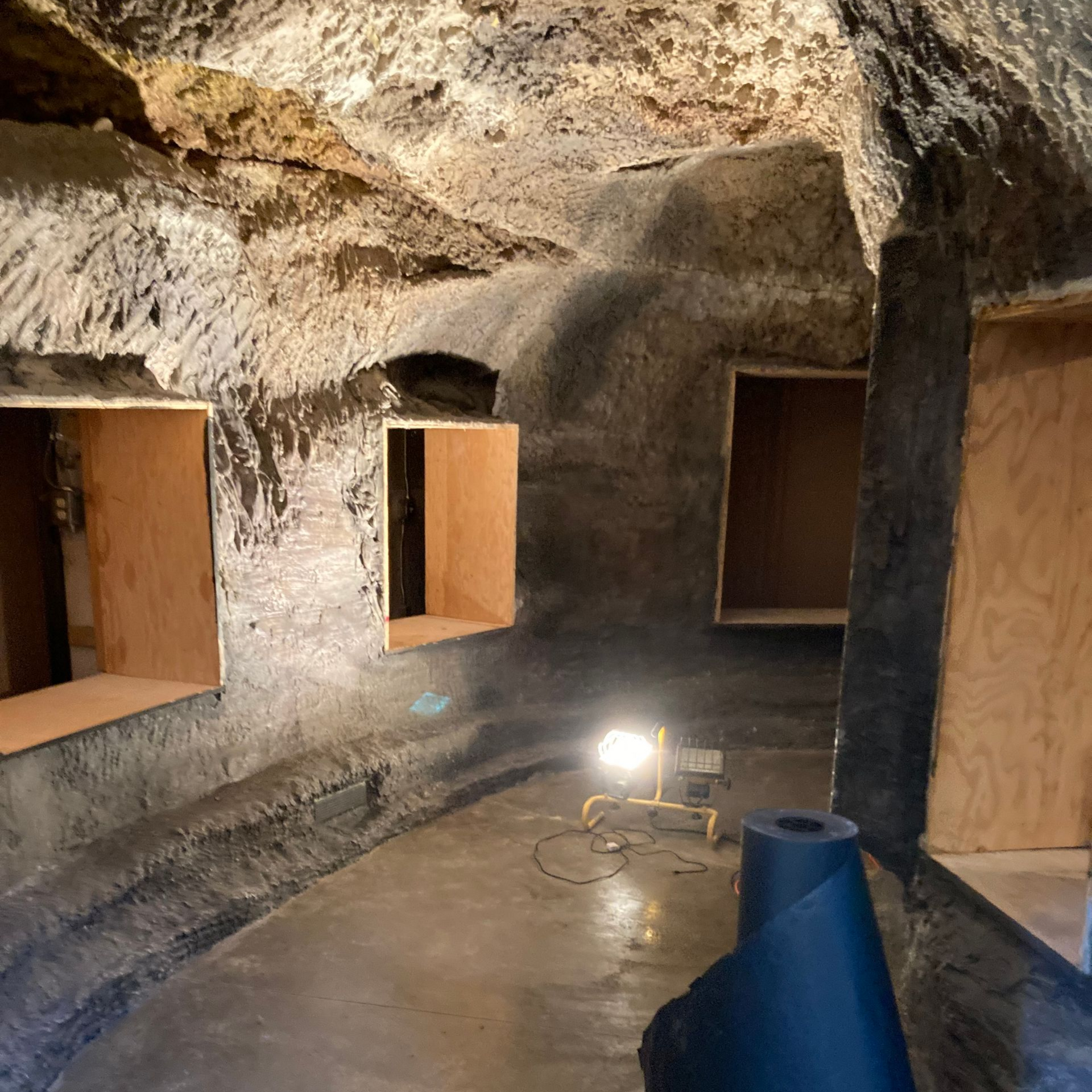 photo of cave exhibit in process, showing the empty exhibit cases inside the cave