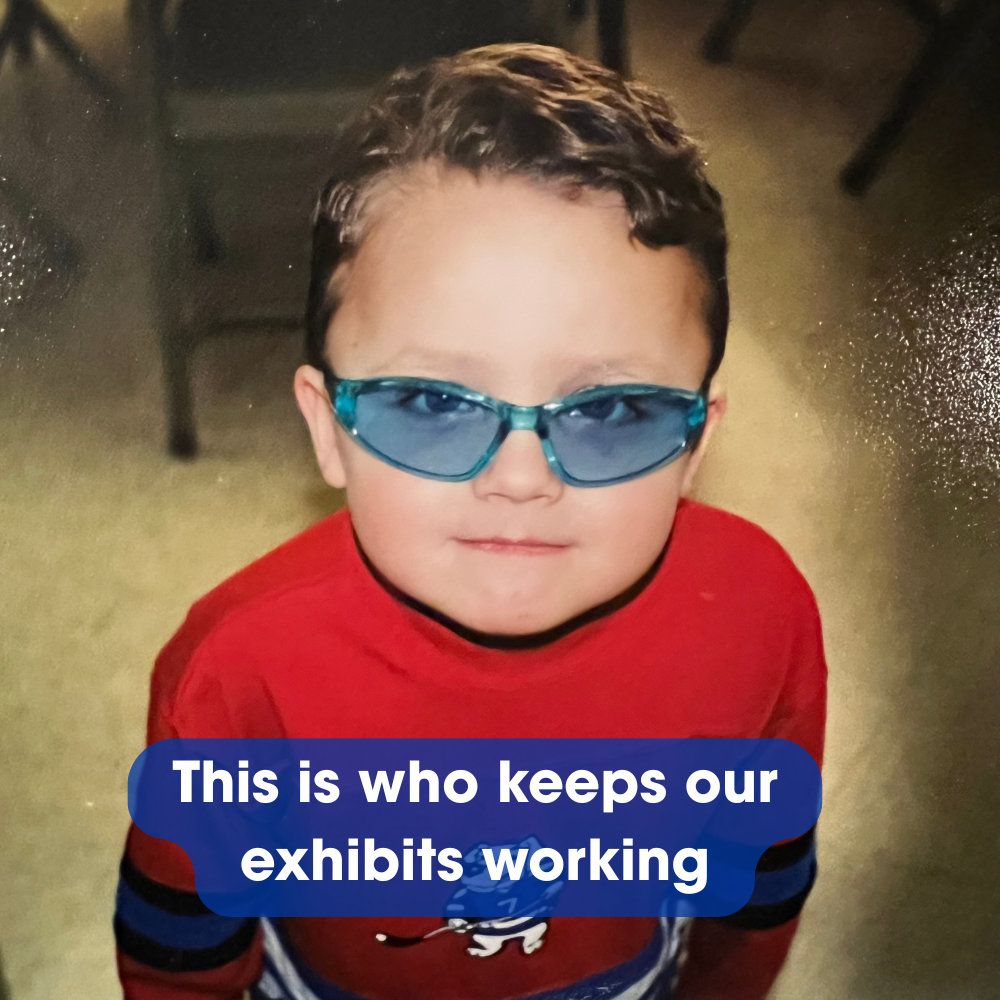 A child wearing blue-tinted sunglasses and a red shirt looks up. Text overlay reads: