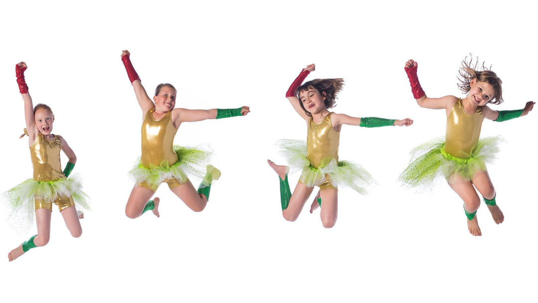 children dancing exuberantly in matching outfits