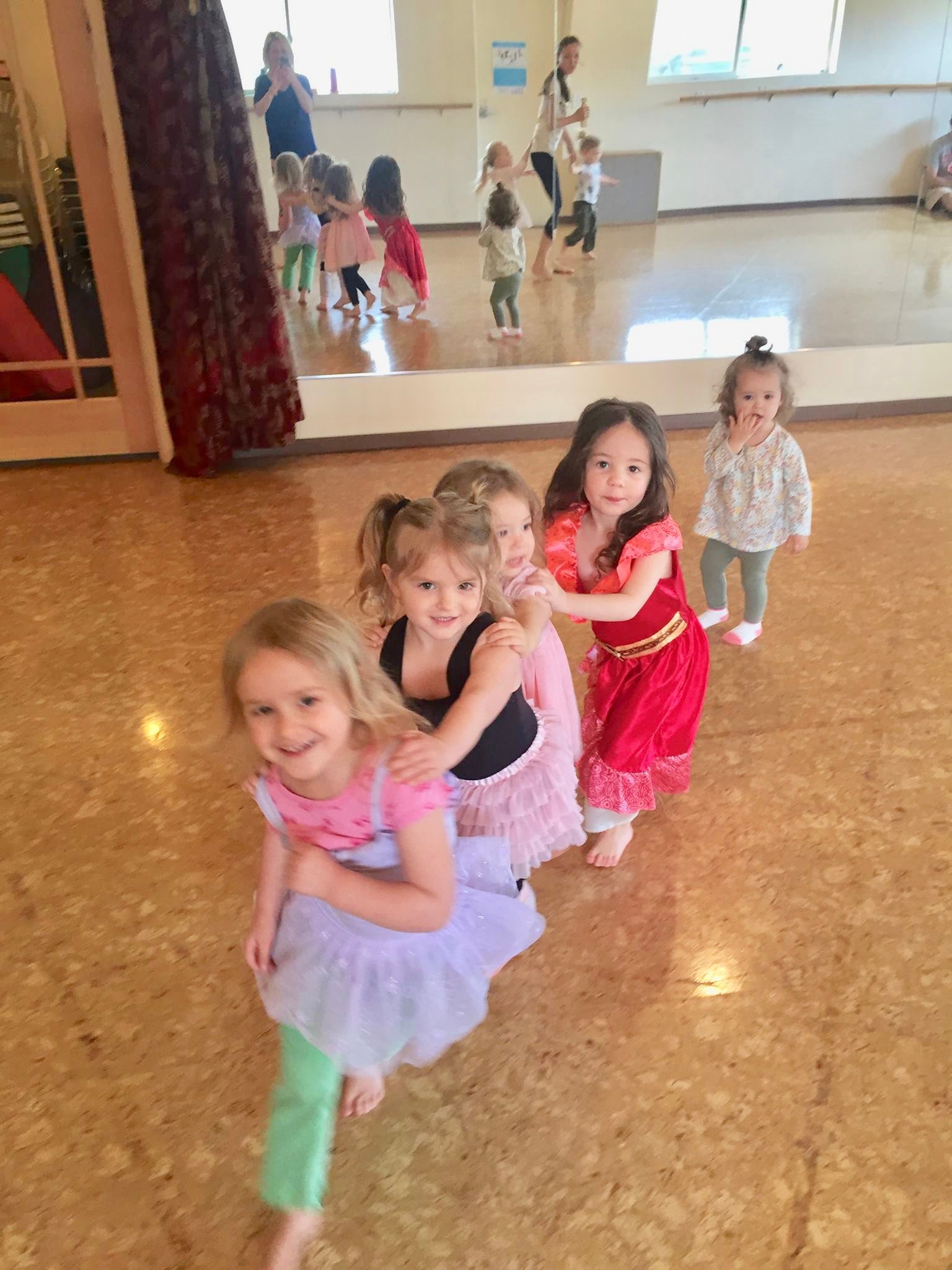 young children dancing in a line