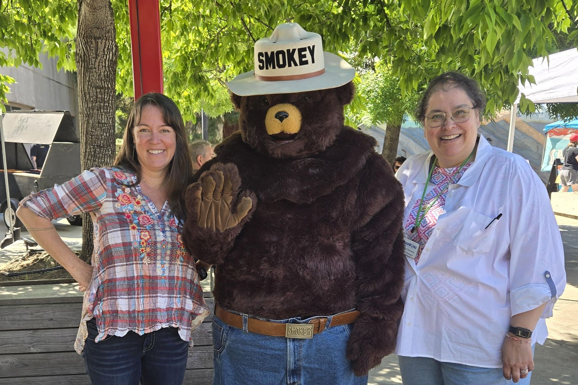 Smokey Bear with two ScienceWorks staff members at Sparking Action! 2025