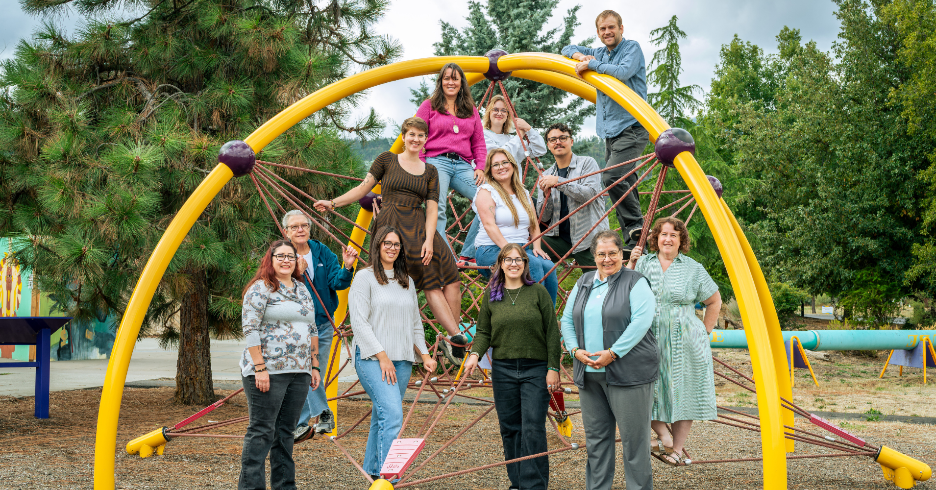 ScienceWorks Staff pose in front of climbing structure outside the museum 2025