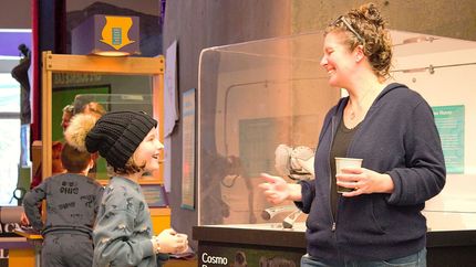 A child and adult chatting and smiling at ScienceWorks Museum