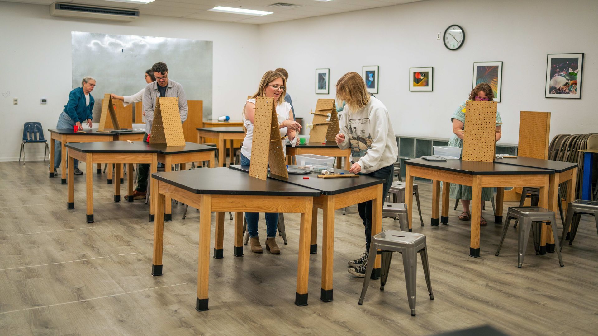 A group of adults working on a momentum workshop in the Galaxy Classroom at ScienceWorks