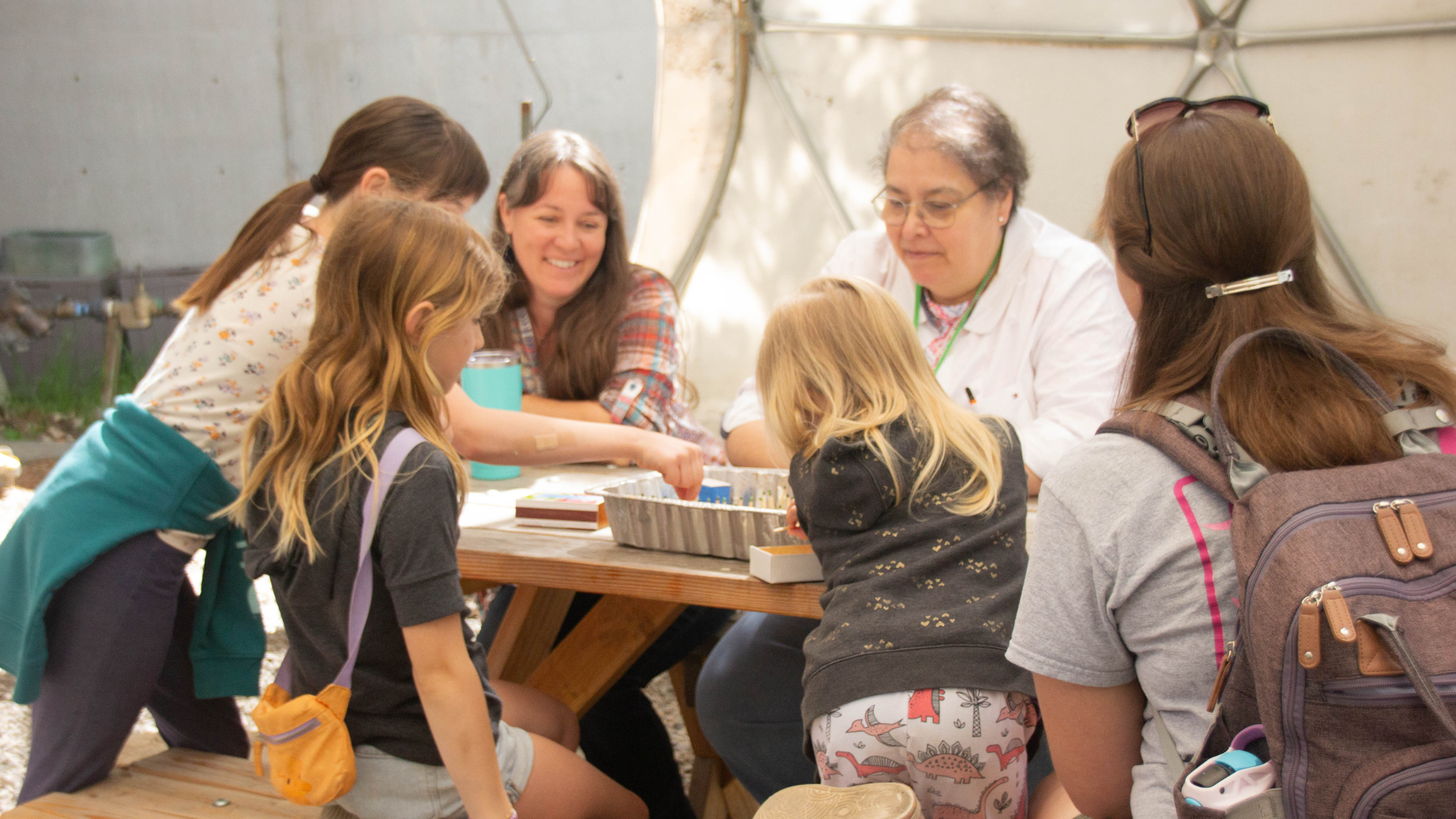 ScienceWorks staff leading a fire ecology activity for a group of adults and kids.