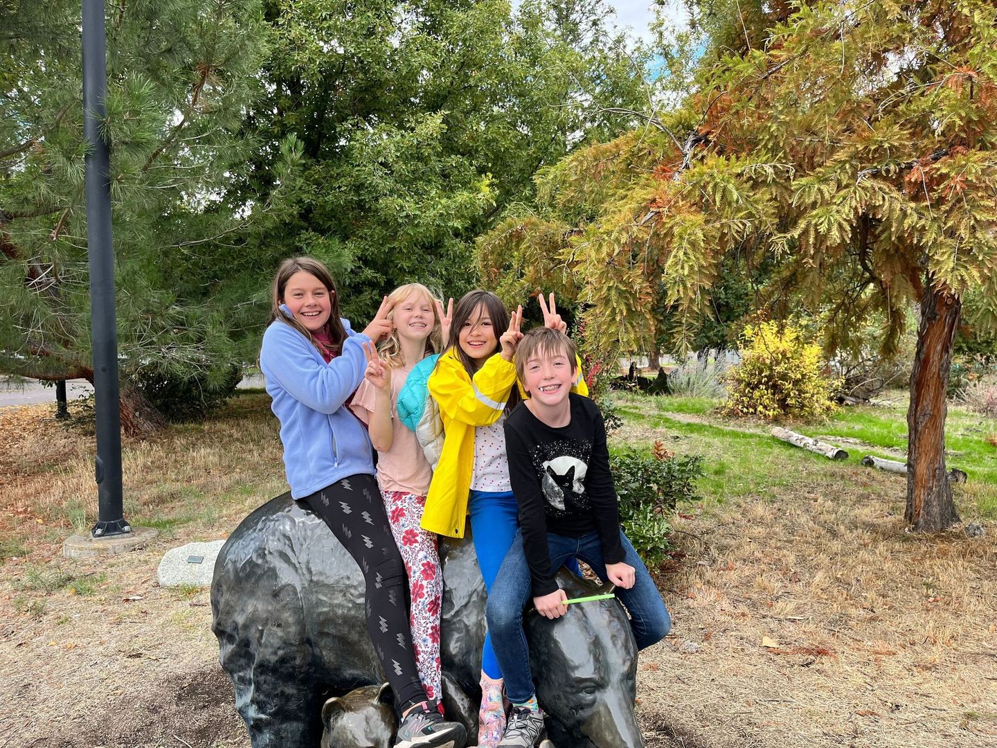 Children sit on the bear statue at ScienceWorks Museum