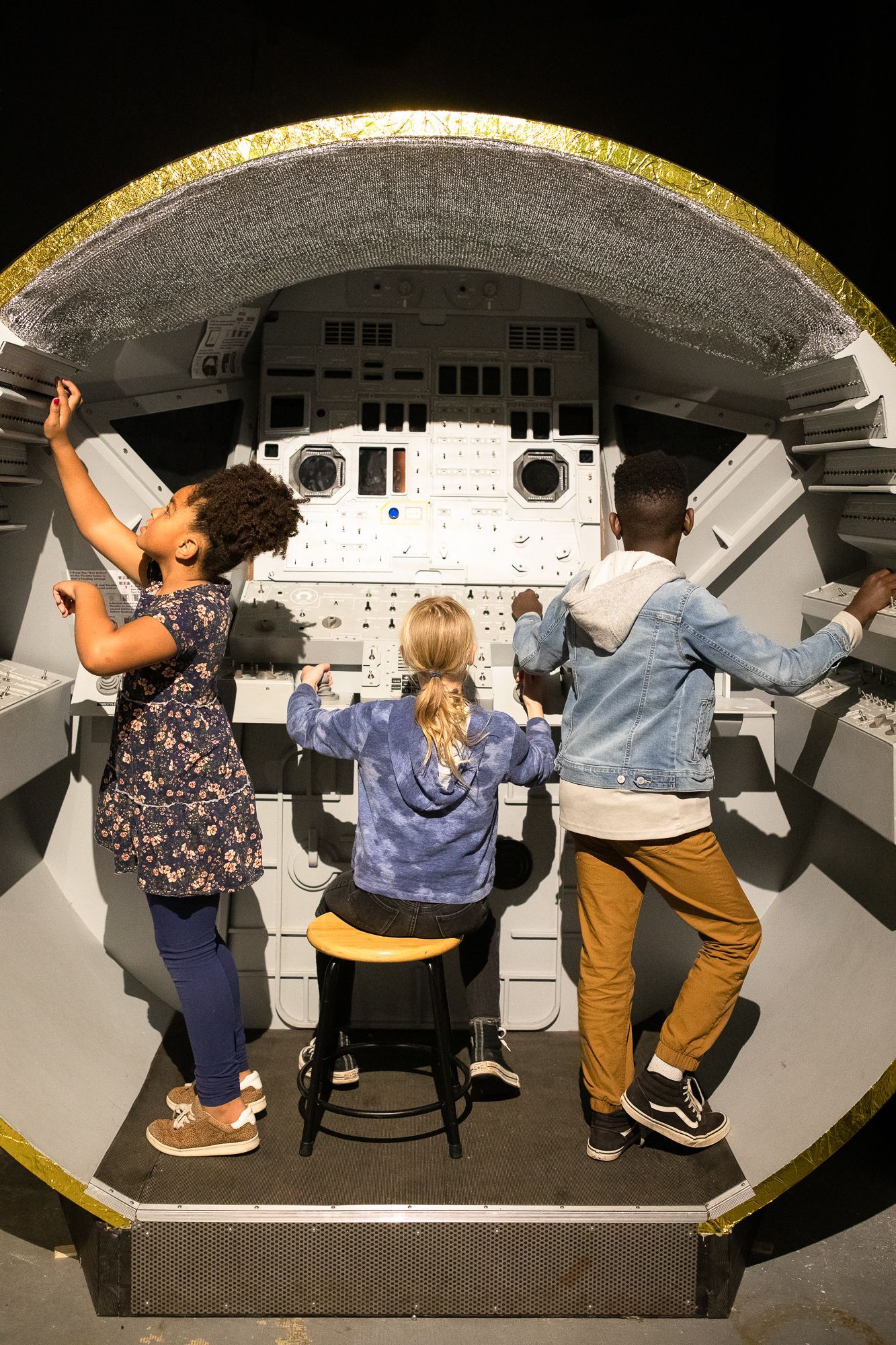 Children playing on ScienceWorks' Lunar Lander exhibit