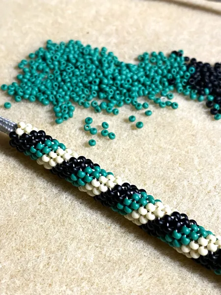 Teal, black, and white beadwork by Morgan Gaines