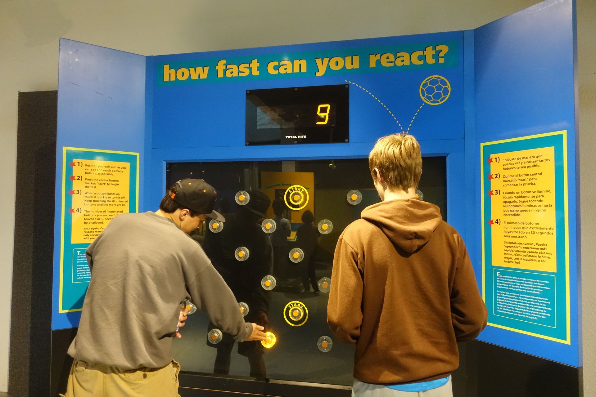 Two men participating in the Reaction Wall Exhibit as part of ScienceWorks' Sportsology Collection.
