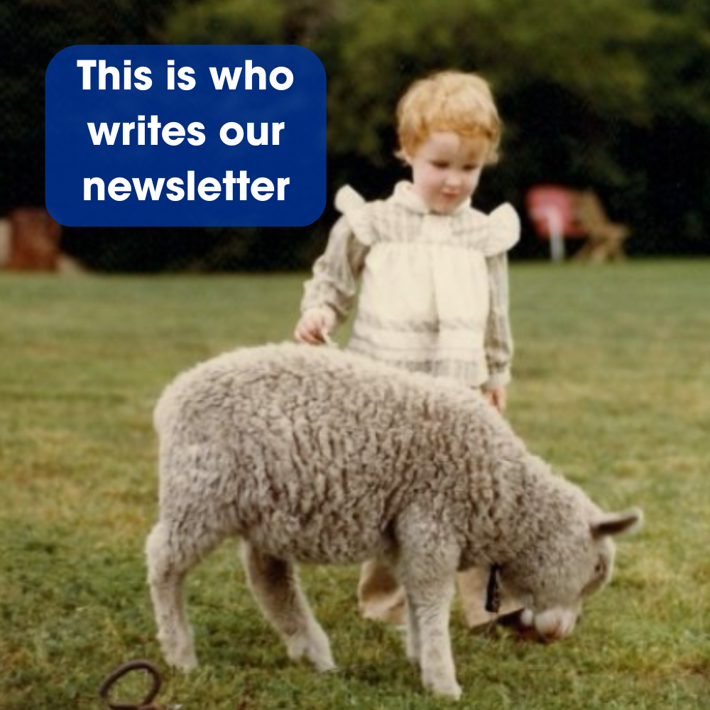 A child in a white vest stands in a grassy field with a lamb, labeled