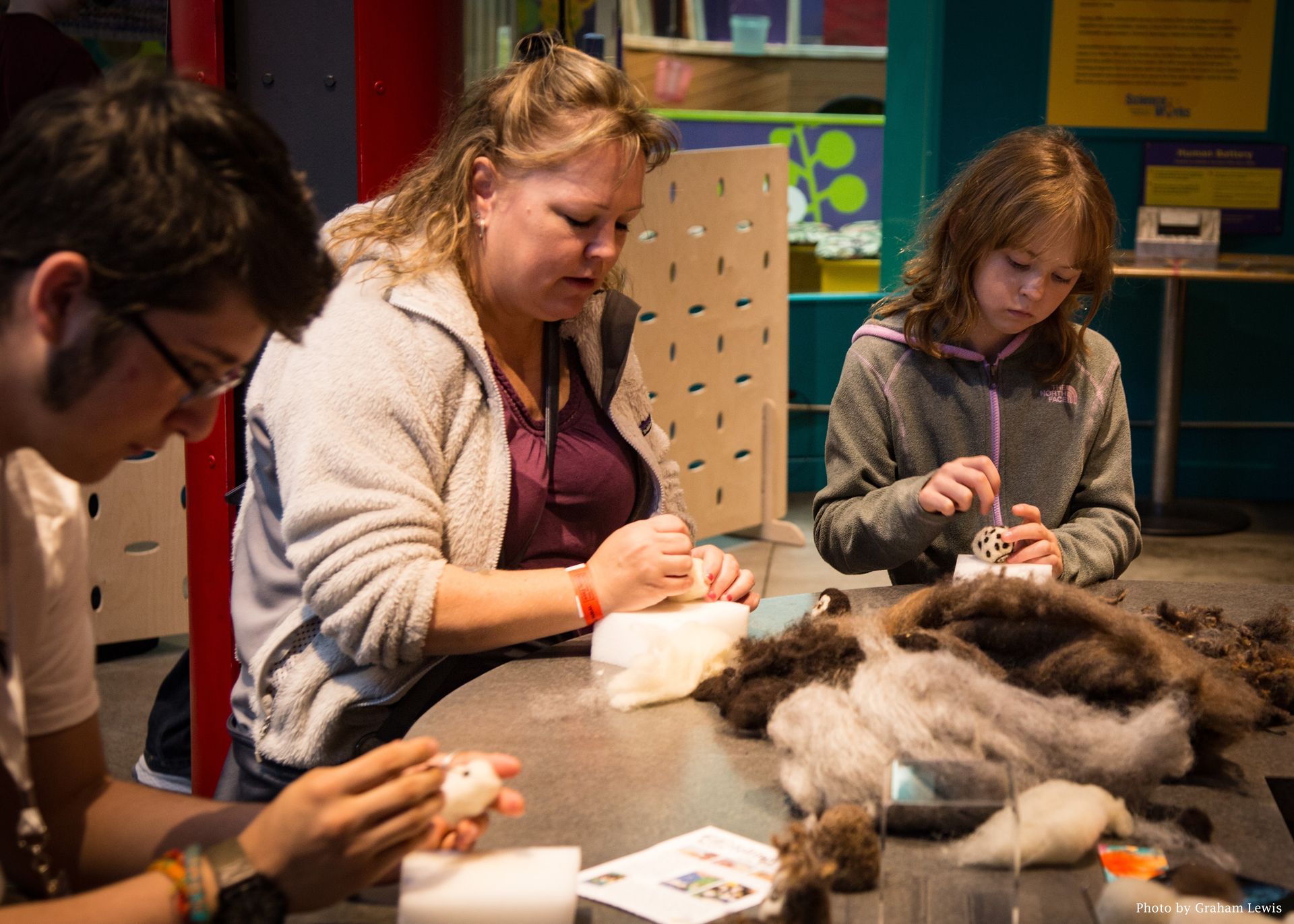 Guests and Volunteers doing a hands-on workshop in the Tinkering Studio