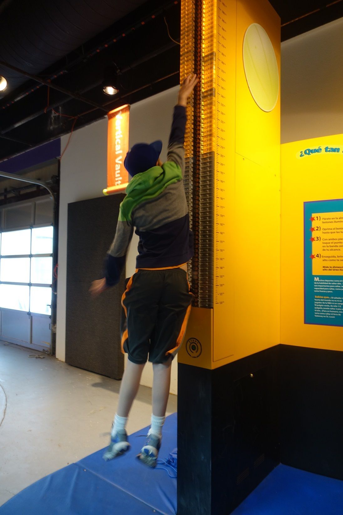 A boy participating in the Vertical Jump Exhibit as part of ScienceWorks' Sportsology Collection.
