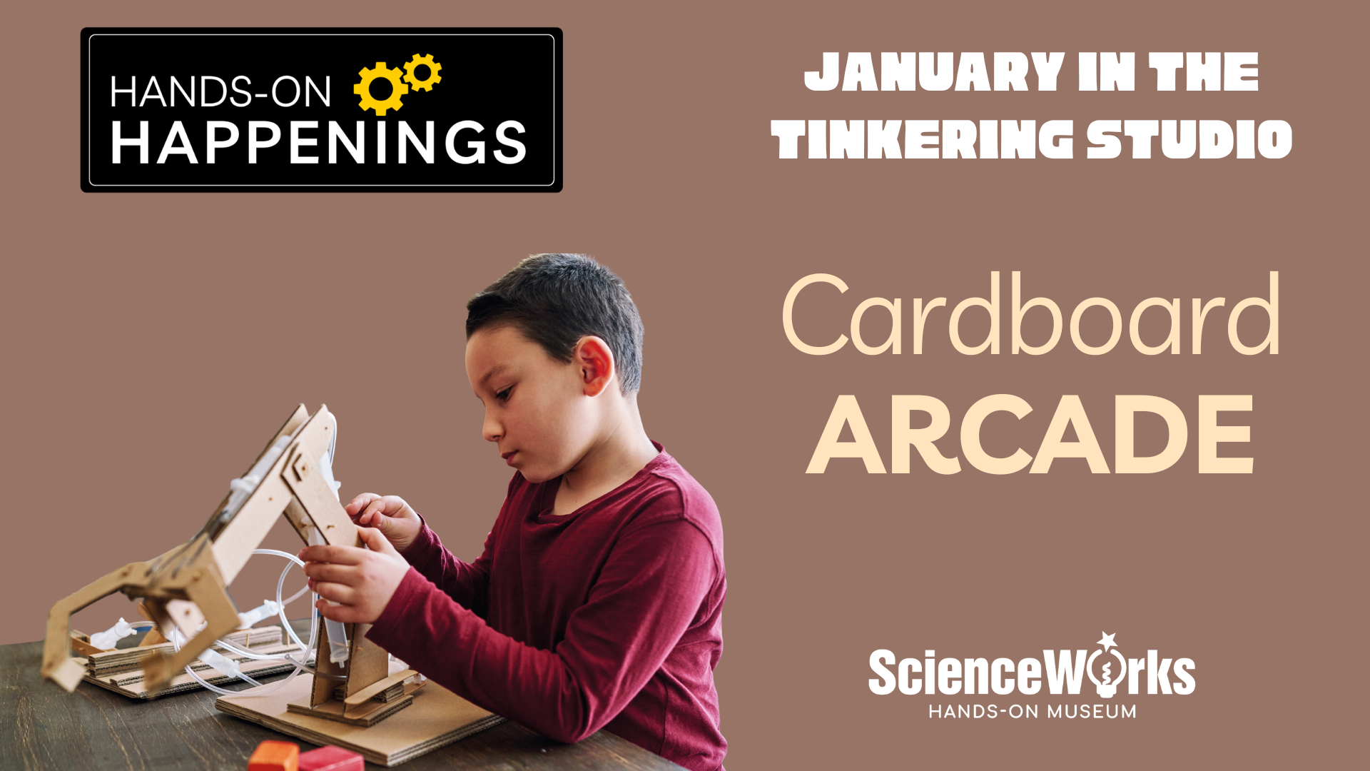 Boy builds cardboard pincer arm in studio. Text reads