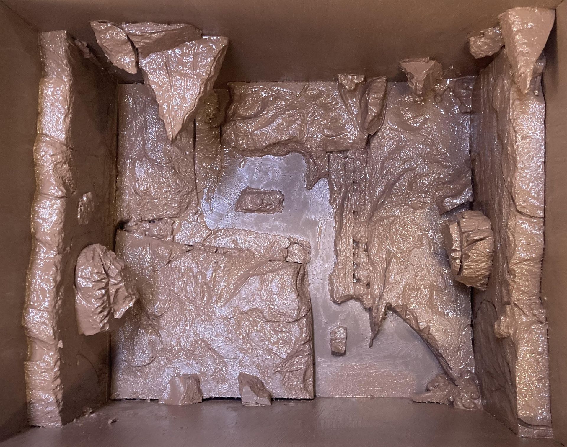 photo of a cave exhibit in process, this is the second stage, showing the foam covered with paint