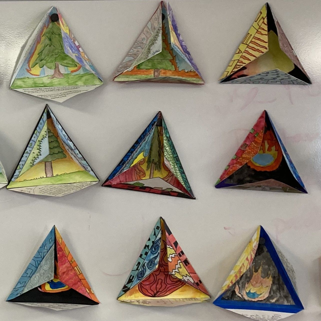 Examples of fire triangles made by students in the Blaze & Brush workshop.