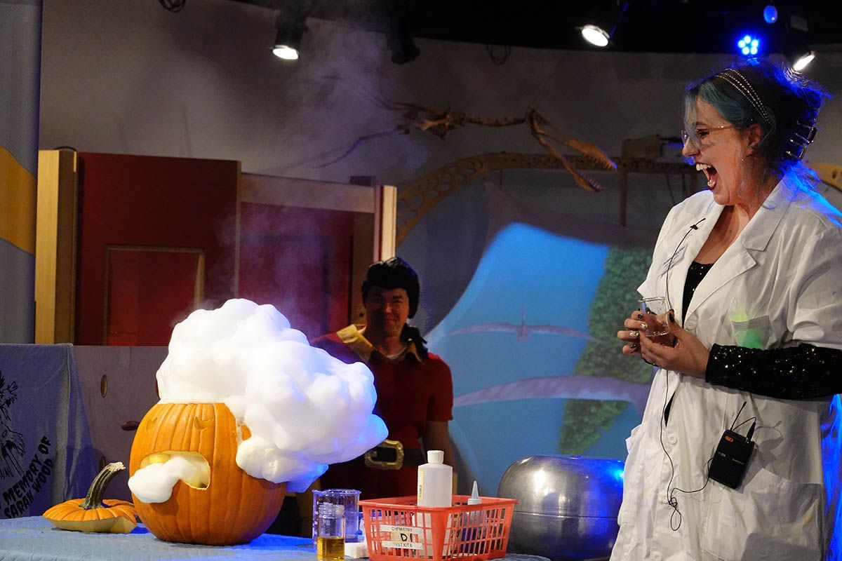 Science gets spooky! At the 2024 Monster Ball, Education Manager Johnnie Snow (in full mad scientist mode) wowed the crowd with the “elephant toothpaste” experiment — a foamy, fast, and exothermic chemical reaction that decomposes hydrogen peroxide into water and oxygen. Meanwhile, Monster Ball Emcee James Ryen lurked ominously in the background, adding an extra dose of eerie fun to the spectacle!