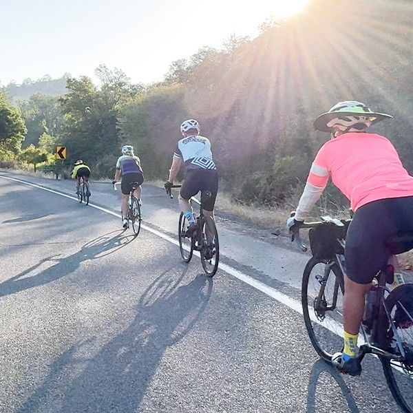 bicyclists riding a twisting road through southern Oregon hills