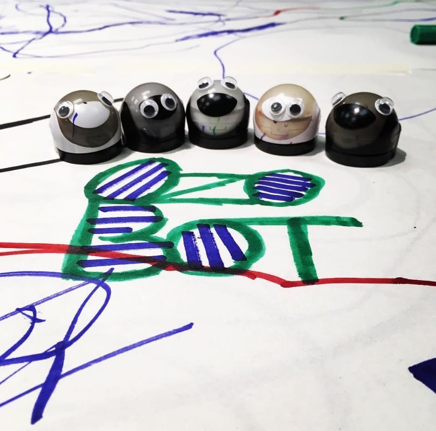 A group of ozobots on a piece of paper.