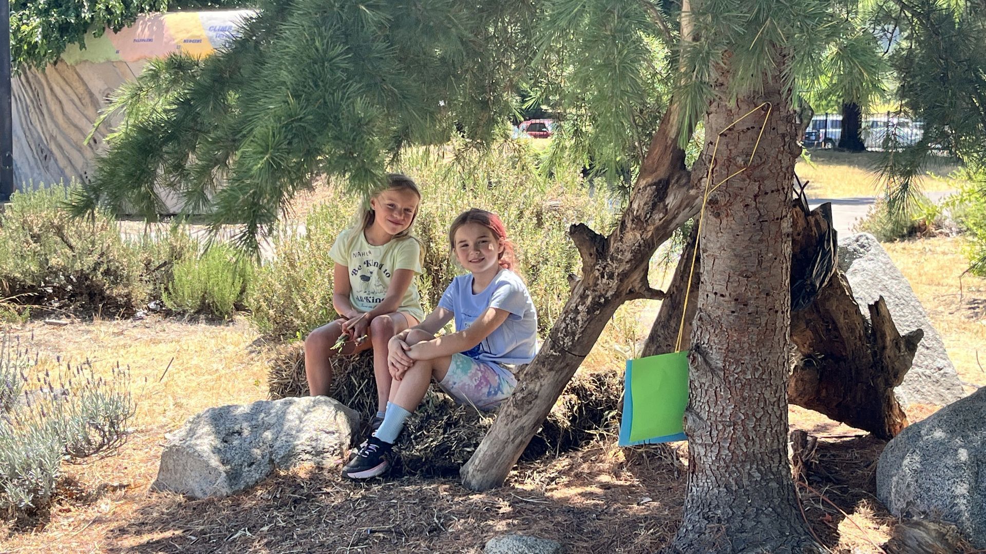 two campers rest in the shade of the bear garden