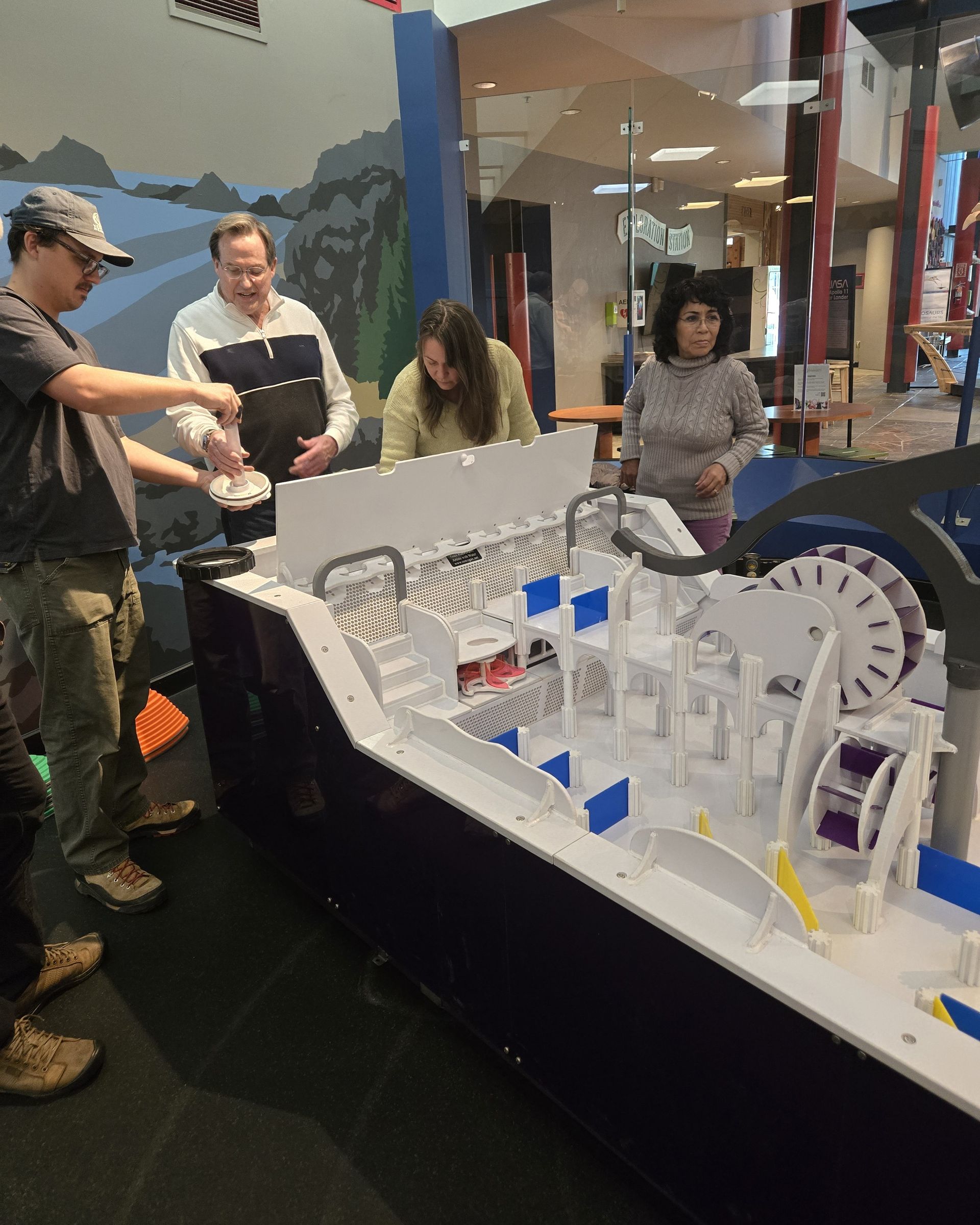 ScienceWorks staff being trained on the water table setup from the fabrication team