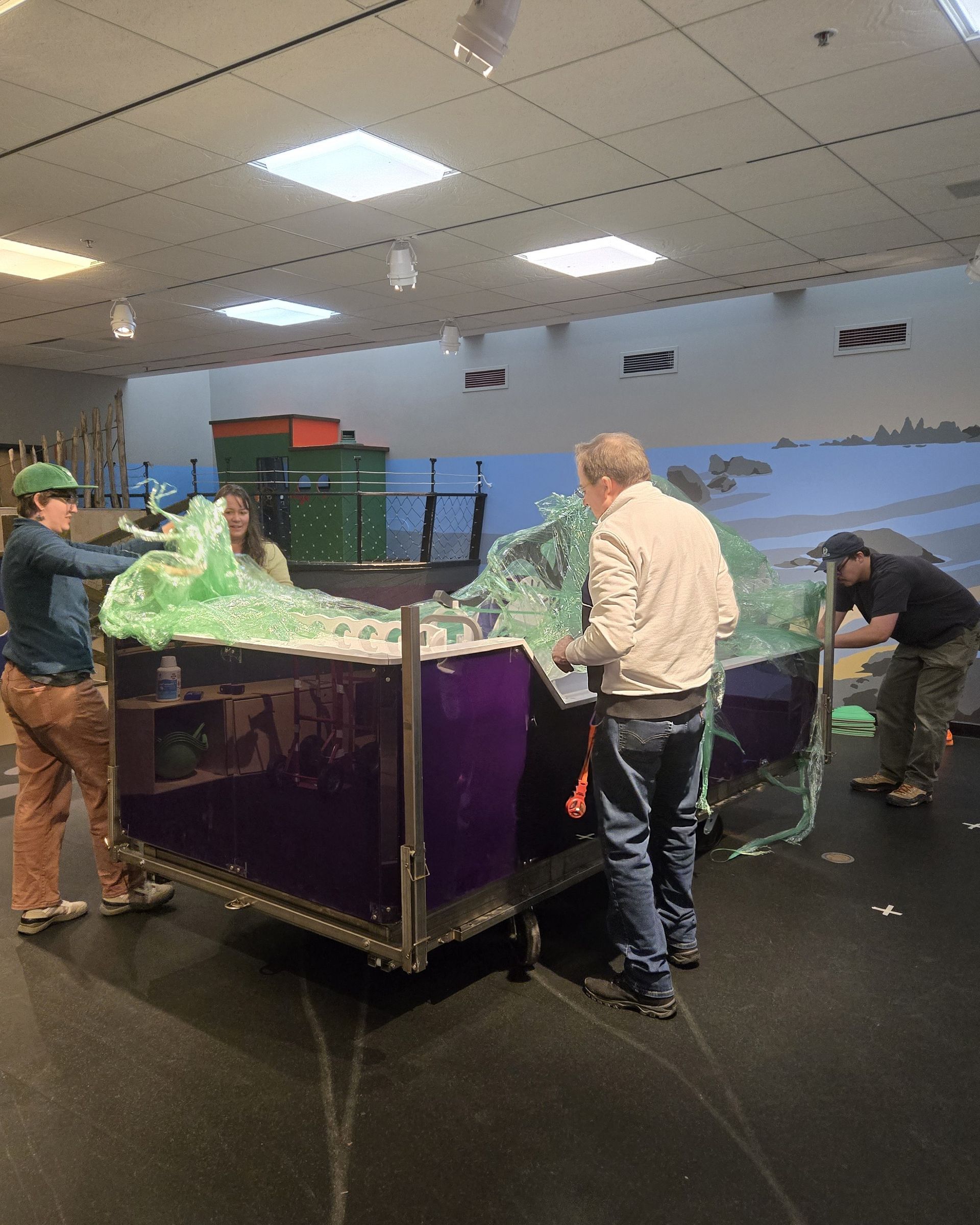 ScienceWorks staff unwrapping the new water table
