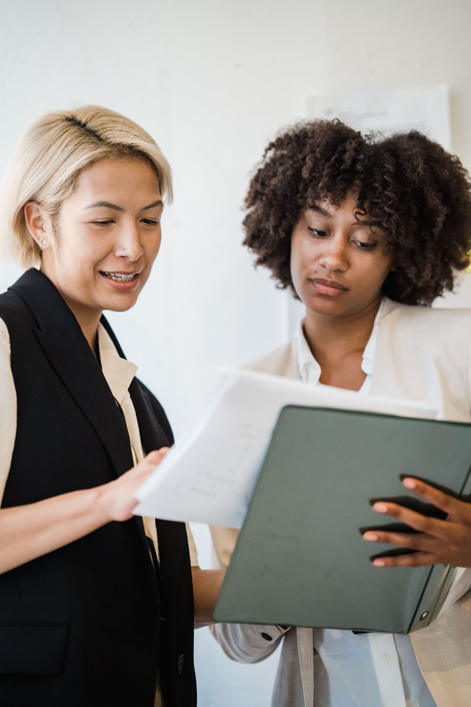 Professional worker and employer reviewing an H-1B petition denial and immigration documents.