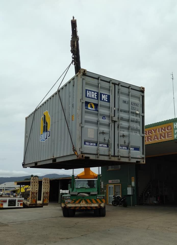 A Large Shipping Container is Being Lifted by a Crane — Bell's Carrying & Crane Hire Service Pty Ltd in Bungalow, QLD