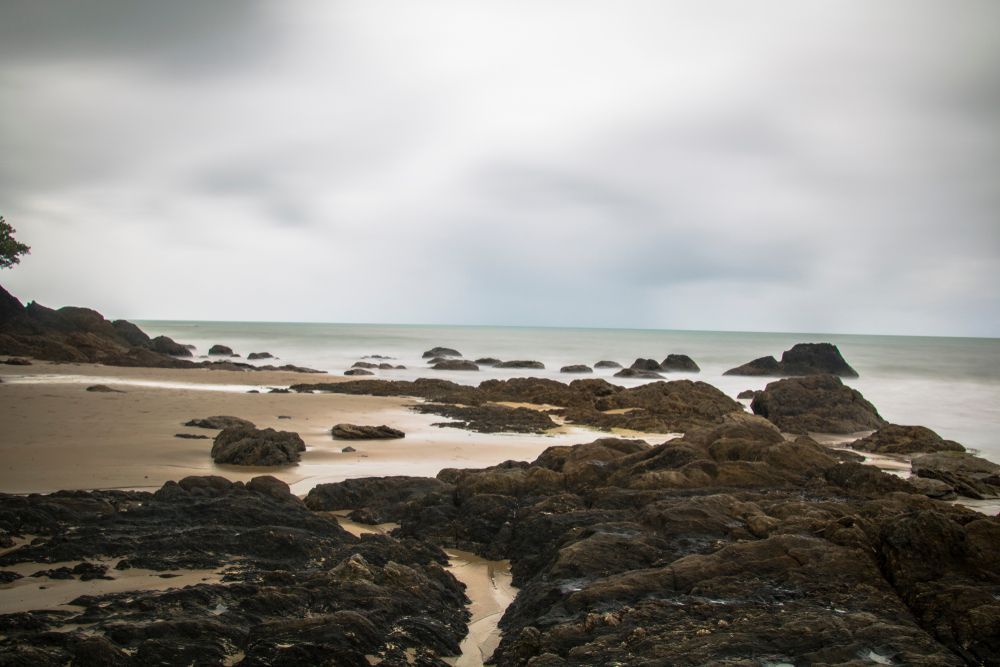 Rocky Beach Under a Cloudy Sky — Bell's Carrying & Crane Hire Service Pty Ltd in Innisfail, QLD